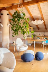 a living room with a chandelier and blue chairs at Il Gomitolo in Biella