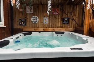 a jacuzzi tub in a room with wooden walls at Elegant 2 bed with hot tub and a host of amenities in Liverpool