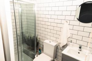 a bathroom with a toilet and a sink and a shower at Elegant 2 bed with hot tub and a host of amenities in Liverpool +116 photos