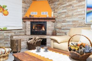 a living room with a fireplace and a couch at PineHouse in Curral das Freiras