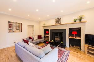 a living room with two couches and a fireplace at self catering , city centre apartment with Parking in Edinburgh