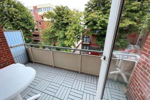 an open door to a balcony with a toilet at Whg Lütt Lee Sandwall 60 Wyk in Wyk auf Föhr