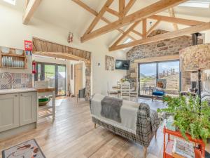 a kitchen and living room with a stone wall at The Hemmel - Uk43357 in Branxton