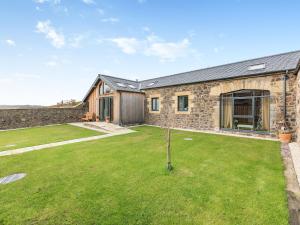 a stone house with a garden in front of it at The Hemmel - Uk43357 in Branxton