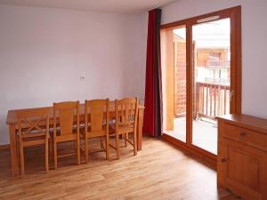ein Esszimmer mit einem Tisch, Stühlen und einem Fenster in der Unterkunft Appartement Les Orres, 3 pièces, 8 personnes - FR-1-322-429 in Les Orres