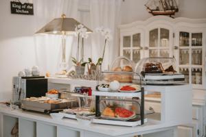 a buffet with various pastries and desserts on a counter at Hotel Villa Vera in Fažana