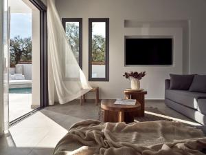 a living room with a couch and a table at Estelle Luxury House in Zakynthos