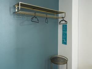 a shower rod in a bathroom with a blue wall at where to sleep in Copenhagen