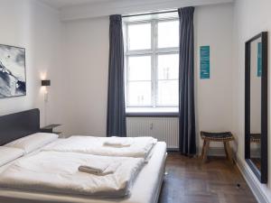 a bedroom with a bed and a large window at where to sleep in Copenhagen