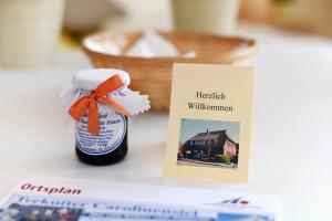 a bottle of honey next to a picture of a house at Apartment Typ C im DG, Haus Friedeburg, Carolinensiel in Wittmund