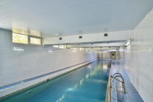 a large swimming pool with blue water in a building at International Home of Scientists Joliot Curie in Saints Constantine and Helena