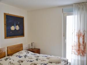 A bed or beds in a room at ROSE DE MAR - Grazioso appartamento con posto auto