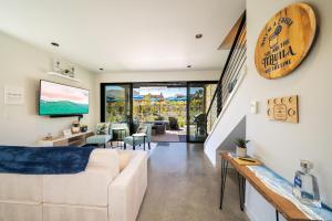 a living room with a white couch and a tv at Tequila Long Time #311 in Chelan