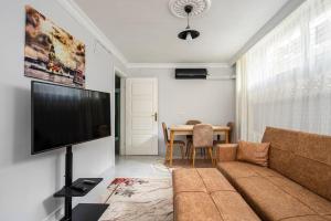 a living room with a couch and a flat screen tv at Central Istanbul Apartments in Istanbul