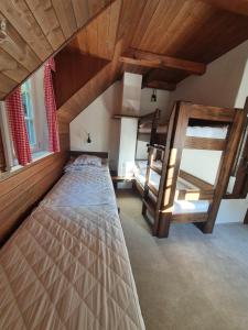 a bedroom with two bunk beds in a attic at BP Chata Ostružná in Ostružná