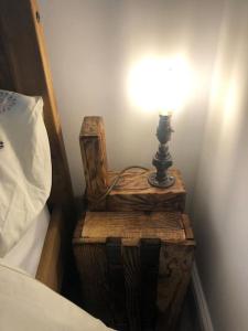 a lamp sitting on a table next to a bed at Loughor Annnex, Llangennech , Wales 