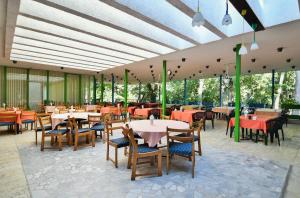 a dining room with tables and chairs and tablesktop at International Home of Scientists Joliot Curie in Saints Constantine and Helena