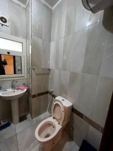 a bathroom with a toilet and a sink at New Cairo Modern Apartment in Cairo