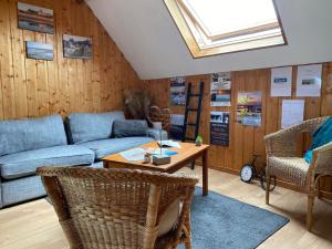 a living room with a couch and a table at Chambres dhotes a la ferme in Forest-Montiers