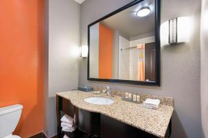 a bathroom with a sink and a mirror at La Quinta by Wyndham Houston IAH Bush Intl Airport E in Humble