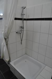 a bath tub in a bathroom with a shower at Charlotten Apartments am Ku'damm in Berlin