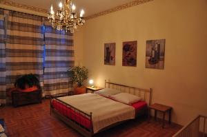 a bedroom with a bed and a chandelier at Charlotten Apartments am Ku'damm in Berlin