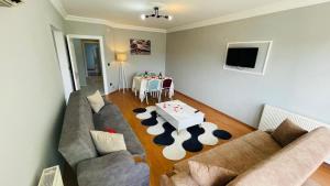 a living room with two couches and a table at Bagdad MOTEL in Akçatepe