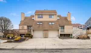 a house with a large house with a garage at Bayside Townhome In Diamond Beach! in Wildwood Crest