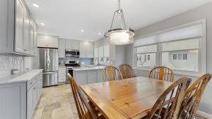a kitchen with a wooden table and chairs at Bayside Townhome In Diamond Beach! in Wildwood Crest