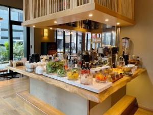a counter with many different types of food on it at Akabane Holic Hotel in Tokyo
