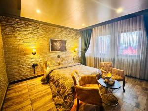 a bedroom with a bed and a table and chairs at GOLDEN ROCK HOUSE in Ankara