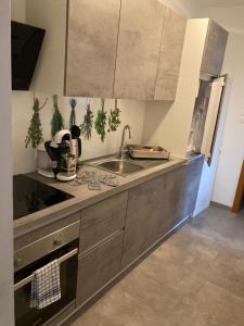 a kitchen with a sink and a counter top at Seecamping & Pension Mentl in Landskron