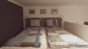 a bed in a bedroom with two pillows on it at Home, far away from Home 2 in Budapest