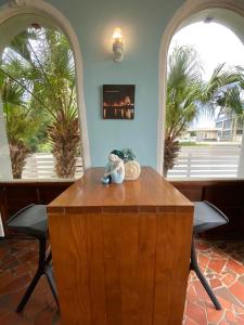 a teddy bear sitting on top of a wooden table at Mermaid Hill Villa in Magong