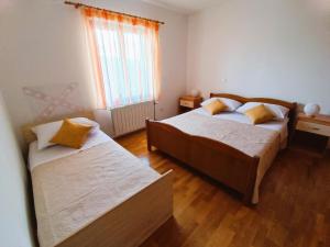 a bedroom with two beds and a window at Apartment Katarina in Split