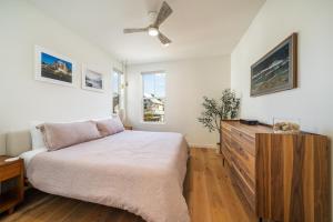 a bedroom with a bed and a ceiling fan at Dock Holiday with Carriage House #134 in Chelan +28 photos