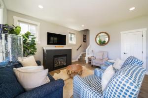 a living room with two blue couches and a fireplace at On Lake Time #86 in Chelan