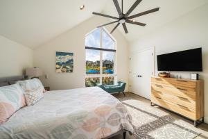 a bedroom with a bed and a flat screen tv at Glamping at the Lake #310 in Chelan