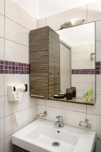 a bathroom with a sink and a mirror at Xerxis Studios in Nea Roda +48 photos
