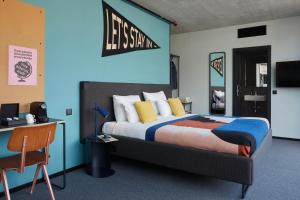 Schlafzimmer mit einem Kingsize-Bett und einem Schreibtisch in der Unterkunft The Social Hub Madrid 4 star in Madrid