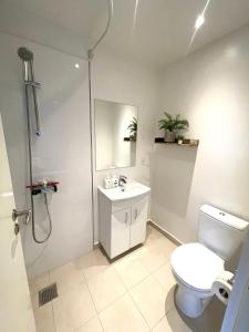 a bathroom with a toilet and a sink and a shower at City Aarhus in Aarhus