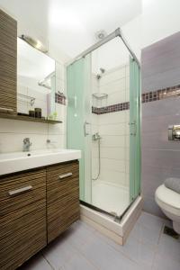 a bathroom with a shower and a sink and a toilet at Xerxis Studios in Nea Roda