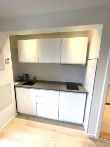 a kitchen with white cabinets and a counter top at City Aarhus in Aarhus