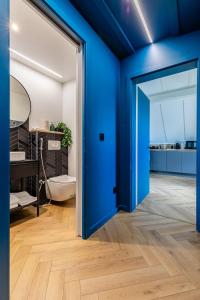 an open blue door in a bathroom with a tub at Appart Cosy Privé Avec parking gratuit aux portes de Strasbourg in Hoenheim