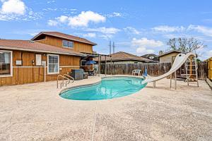 a swimming pool with a slide and a playground at Hidden Treasure in Corpus Christi