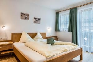 a bedroom with a large bed in front of a window at Feldererhof Apt Hochstein in Santa Maddalena