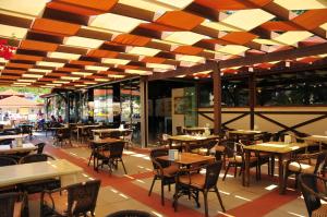 an empty restaurant with tables and chairs in a building at Telmessos Neva Hotel - Halal-Non Alcoholic All Inclusive-Muhafazakar Hotel in Oludeniz