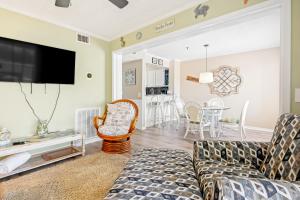 a living room with a couch and a tv at Hillside 304 in Myrtle Beach