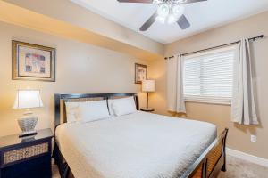 a bedroom with a bed and a ceiling fan at Sterling Breeze 1705 in Panama City Beach