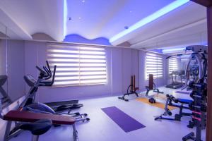 a gym with several tread machines in a room at Telmessos Neva Hotel - Halal-Non Alcoholic All Inclusive-Muhafazakar Hotel in Oludeniz